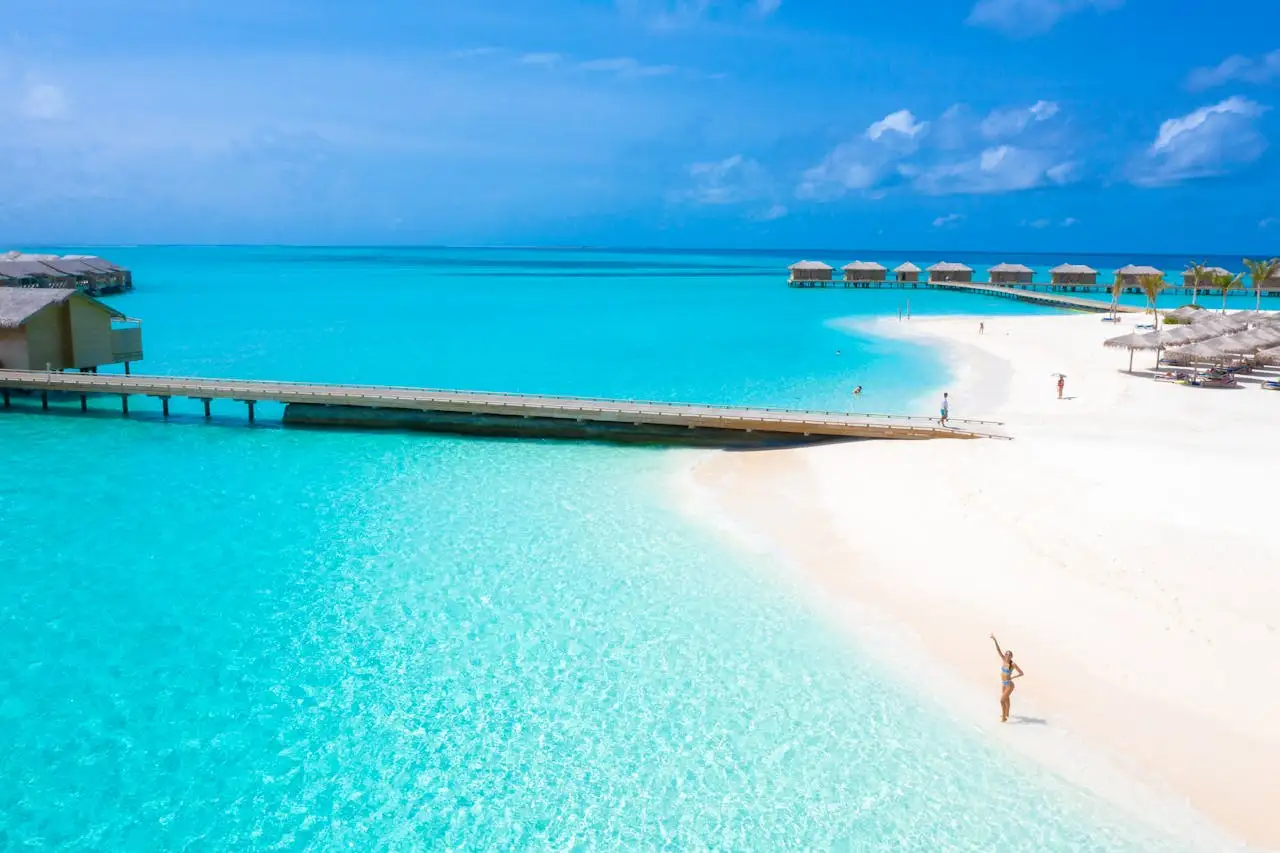 A shallow reef flat and overwater villas in a Maldivian atoll