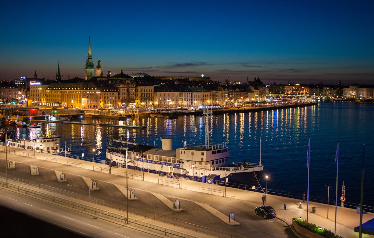 Stockholm waterfront promenade in summer with sailboats and colorful buildings